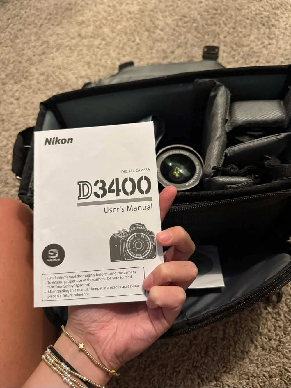 Nikon Black DSLR with Zoom Lens and Branded Neck Strap